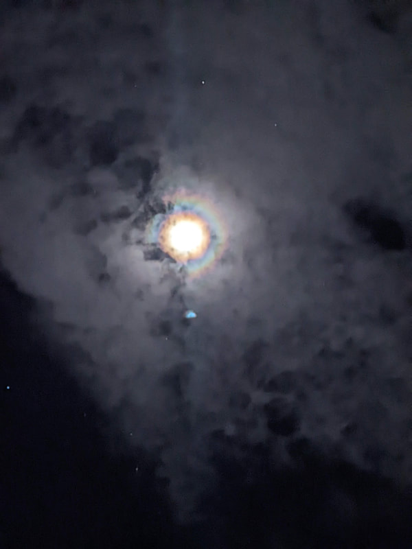 Blurry picture of the moon on a cloudy night